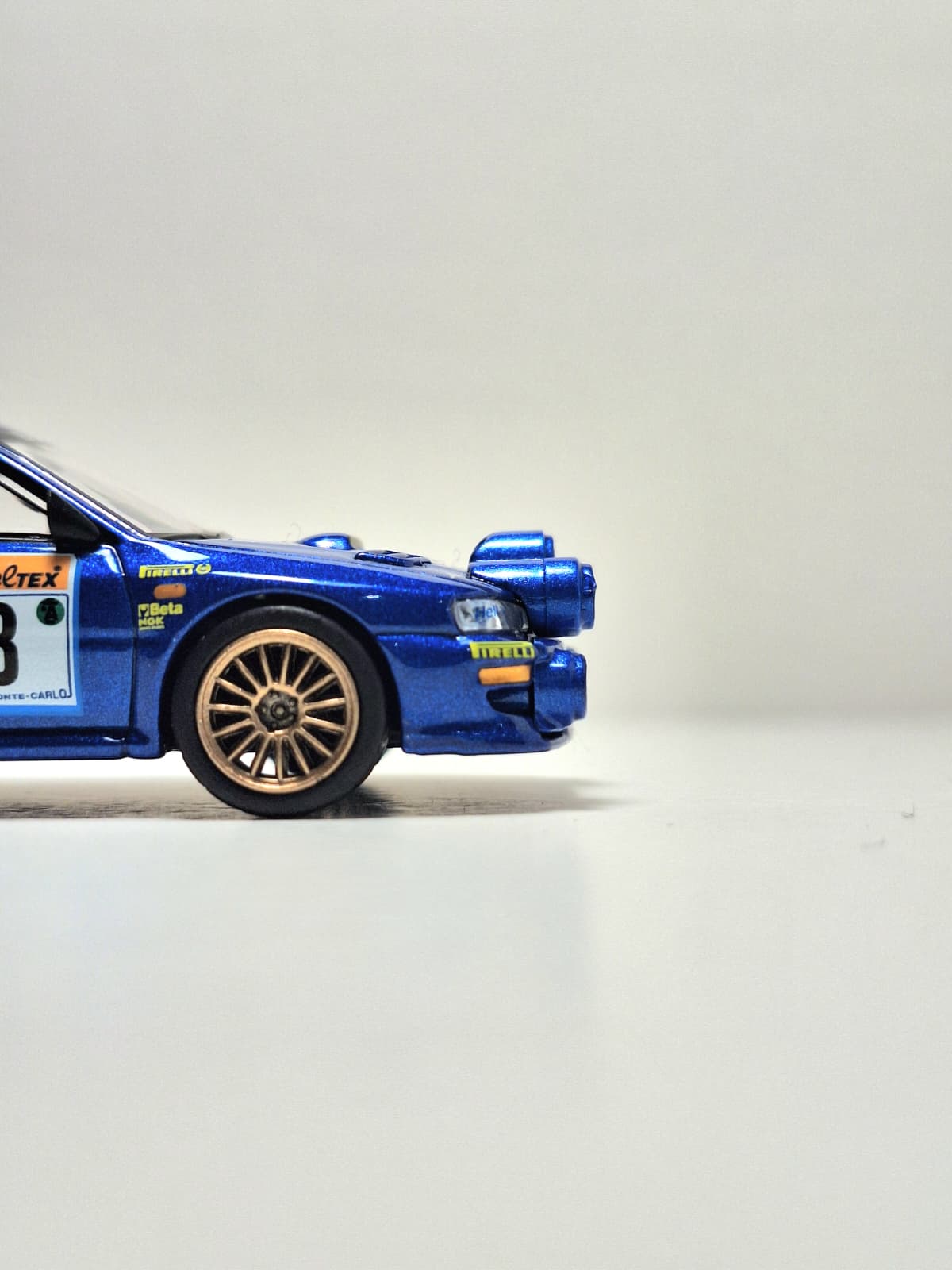 Detail of a Subaru rally model with livery and sponsor markings